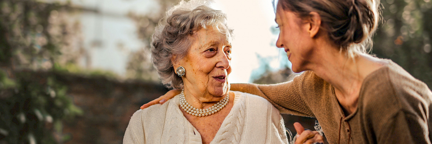 Elderly woman with caretaker